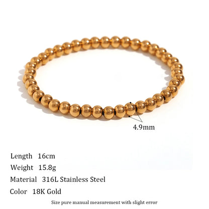 Product shot of a 4.9mm gold beaded stretch bracelet on a white background with specifications for length, weight, and 316L stainless steel material, emphasizing its medium bead size | Oria Jewel