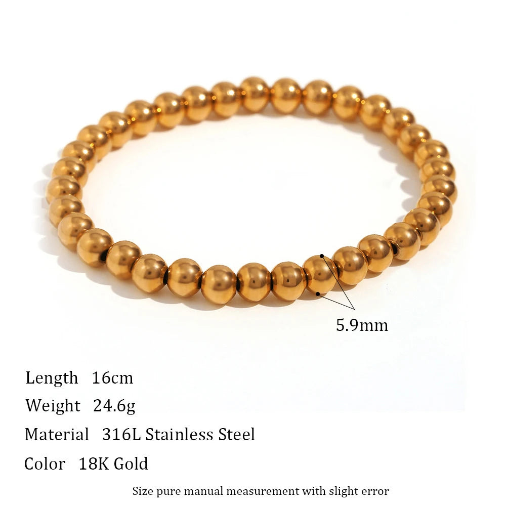Product shot of a 5.9mm gold beaded stretch bracelet on a white background with printed measurements and details, highlighting the larger statement bead size and solid, weighty feel | Oria Jewel