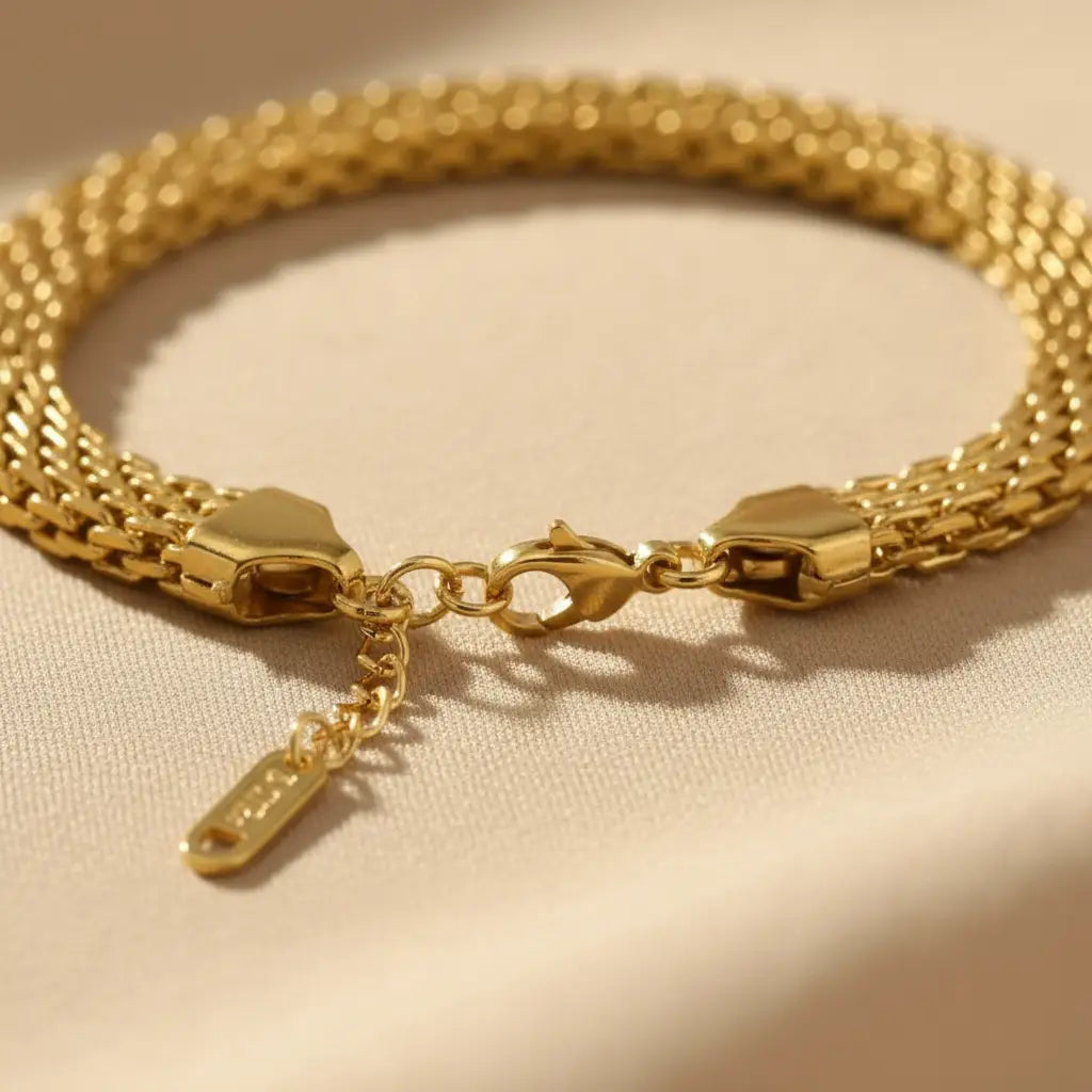 Detailed close-up of clasp and extender chain on polished gold wheat chain bracelet | Oria Jewel
