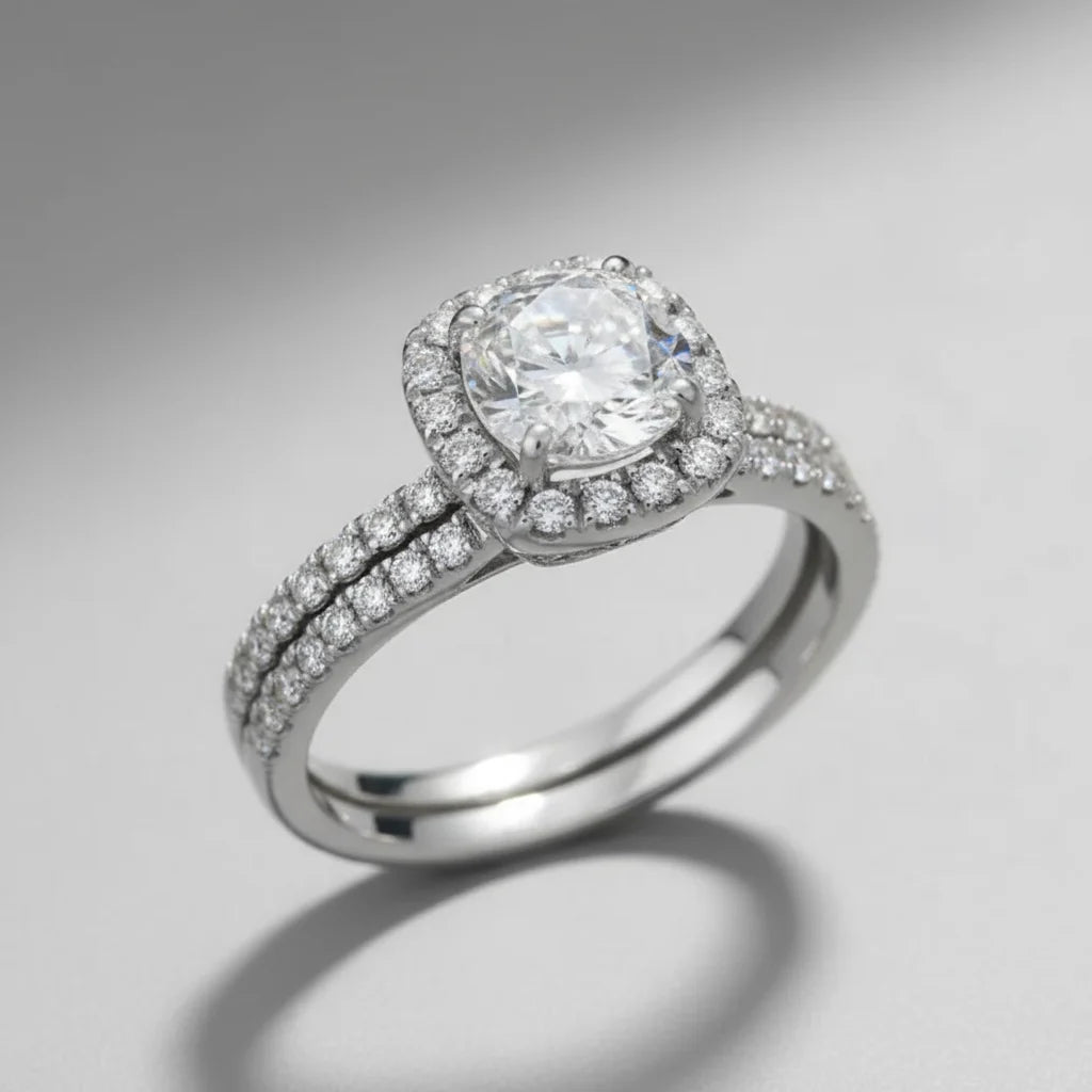 Soft Shine Halo Ring studio product photo on a clean grey background, angled view showing the raised halo setting, prongs, and pavé detailing across the band | OriaJewel
