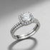 Soft Shine Halo Ring studio product photo on a clean grey background, angled view showing the raised halo setting, prongs, and pavé detailing across the band | OriaJewel