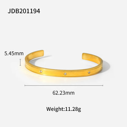 Product diagram of a gold statement cuff bracelet on a white background showing 5.45 mm band width, 62.23 mm inner diameter and weight of 11.28 g for sizing reference | Oria Jewel
