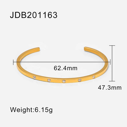 Product diagram of a thin gold cuff bracelet on a white background showing inner diameter 62.4 mm, height 47.3 mm and weight 6.15 g for precise sizing details | Oria Jewel